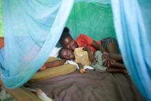 In Ghana, mother and son under an insecticide-treated bed net they received to protect them from mala